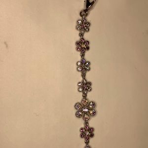 Pink and white gem flower and silver tone bracelet.